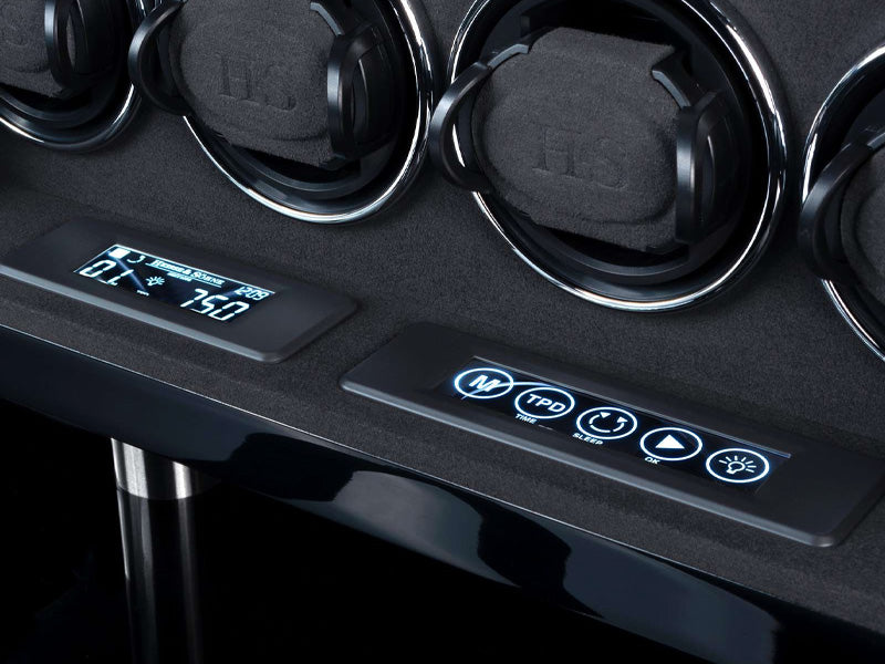 Black watch winder with digital display and control buttons on a dark background